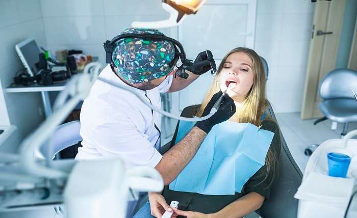 dentist curing female patient s teeth 23 2147862071