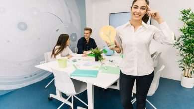 smiling businesswoman with idea concept holding paper light bulb 23 2147826568