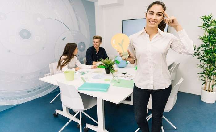 smiling businesswoman with idea concept holding paper light bulb 23 2147826568