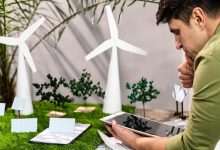 side view man using tablet eco friendly wind power project layout 23 2148847800