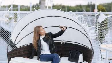 woman sitting wicker armchair with umbrella making auto photo 1157 2329