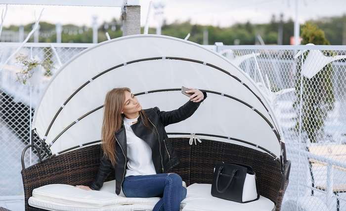 woman sitting wicker armchair with umbrella making auto photo 1157 2329