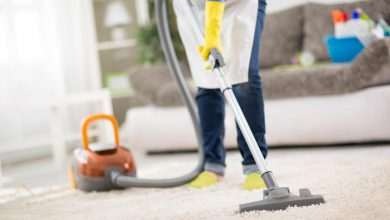 housewife clean carpet with vacuum