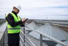 portrait construction worker standing rooftops high silos storage tanks working tablet computer 342744 441