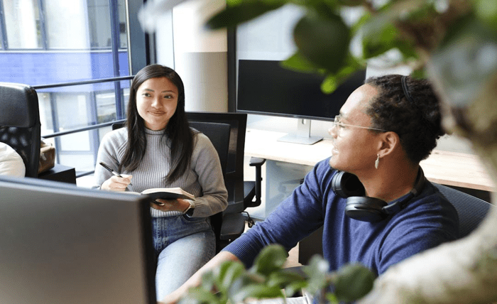 Employees collaborating on proposal management software to streamline workflow and enhance team coordination